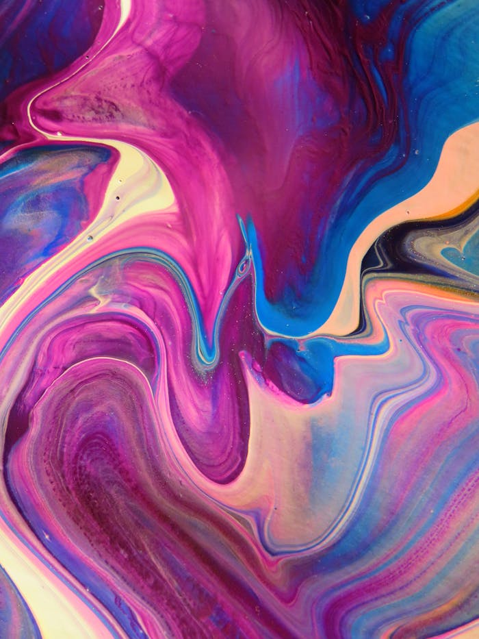 about-img A dynamic abstract artwork featuring swirling patterns in vivid pink, blue, and purple hues.